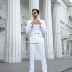 A sharp, all-white suit against the grand architecture of Mumbai creates a high-contrast, powerful statement. This is the kind of shot that stands out in a men's fashion portfolio.