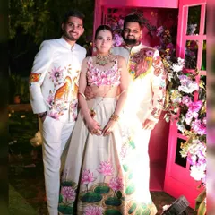 I love creating coordinated pieces for the wedding party. Here, two members of the bride's tribe wear my custom hand-painted jackets, one featuring a regal lion and the other a delicate bird motif, creating a cohesive yet individual look.