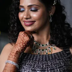 A close-up of her gorgeous makeup look. The shimmering blue eyeshadow and flawless skin pair beautifully with her natural hair.