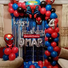 A classic Spiderman birthday backdrop for Omar, featuring a blue shimmer curtain, a red, blue, and black balloon arch, and multiple Spiderman foil balloons. The silver foil letters for the name and age add a personalized touch.