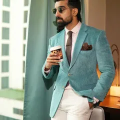 A moment of quiet confidence in our aqua corduroy blazer. The vibrant color is a refreshing alternative to traditional navy or grey, perfect for the man who wants to express his personal style.