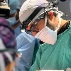 The level of focus and precision required for gender-affirming surgery is immense. Here, Dr. Kothari is performing a procedure during a specialized workshop, demonstrating the meticulous care we bring to every single hair follicle we transplant.