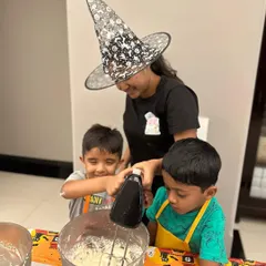 My kids' workshops are 100% hands-on. I guide them, but they do all the fun stuff themselves, from using the mixer to whipping up frosting for their spooky Halloween cupcakes.