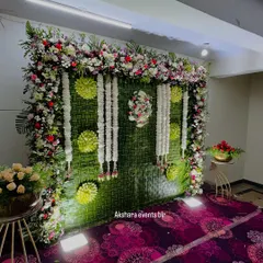 This elegant naming ceremony backdrop is made from woven banana leaves and adorned with garlands of fresh white jasmine. The floral frame adds a touch of grandeur to the setting.