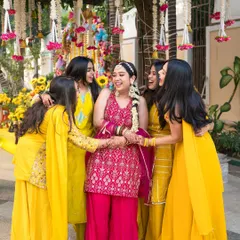 The bride surrounded by her best friends, sharing a laugh during the Haldi ceremony. These are the unscripted moments with your bride tribe that you will cherish forever.
