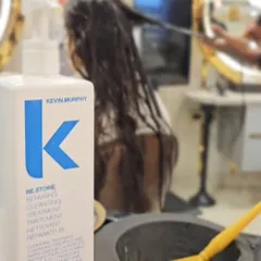 A close-up of the Kevin Murphy RE.STORE cleansing treatment. This is a client favorite for repairing and nourishing damaged hair during a spa session.