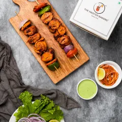 Another look at our Tandoori Soya Chaap, presented with a side of pickled onions and mint chutney. The rich marinade gives each piece a deep, savory flavor that's both hearty and delicious.