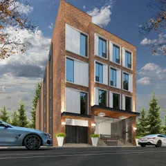 A commercial building with a classic brick facade, updated with modern, large windows and clean lines. The design is intended to fit within an urban context while offering a contemporary workspace.