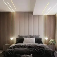 I create serene and luxurious master bedrooms that feel like a personal retreat. This design uses a combination of vertical wood paneling, a plush upholstered headboard, and layered ambient lighting to build a warm and inviting atmosphere.