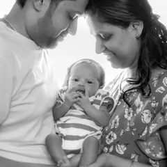 The beginning of a new family story. This black and white portrait captures the tender, loving bond between new parents and their precious newborn, a timeless memory to hold onto forever.
