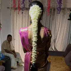 A stunning example of a traditional South Indian bridal braid, completely covered in fragrant jasmine flowers for a classic and beautiful look.