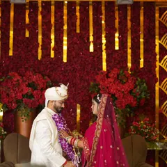 The Varmala ceremony is full of emotion. I captured this moment of the couple looking at each other, with the grand red and gold decor creating a royal backdrop.