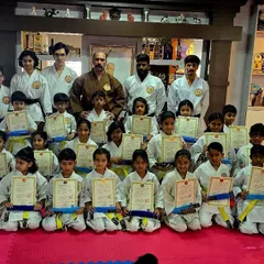A group of our young students proudly holding their new belts and certificates after a successful karate belt test. This moment marks a significant step forward in their martial arts journey.