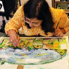 An adult student works on a textured landscape painting. My classes offer a chance to explore different mediums, from smooth watercolors to thick acrylics.
