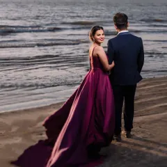 A cinematic moment at dusk. The way her gown catches the sea breeze creates a truly dramatic and romantic pre-wedding portrait. This is about making you feel like the heroes of your own love story.