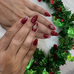 Perfect for the festive season or a glamorous party. These deep red almond nails feature intricate, hand-placed diamond stones that catch the light beautifully.