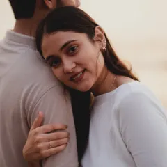 A beautifully intimate portrait from a Mumbai pre-wedding shoot. The soft focus and her peaceful expression as she rests on his shoulder create a feeling of trust and serenity.