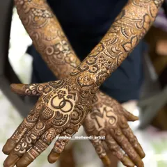 This engagement design features interlocking rings on one palm and the couple's initials 'MS' on the other, surrounded by detailed floral and geometric patterns.