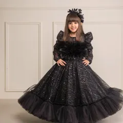 The twirl of this black gown shows off its volume and the beautiful texture of the embroidered fabric.