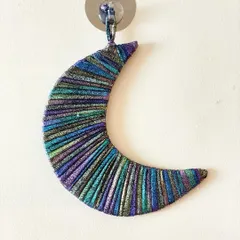 This shimmering crescent moon is a beautiful little charm. The special metallic cord I used catches the light and creates a magical, iridescent effect.