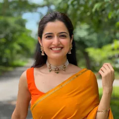 It was such a pleasure to design for the gorgeous actress Ashika Ranganath. I created this simple yet vibrant orange sleeveless blouse to perfectly complement her colorful saree.