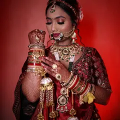 This stunning bride in her red lehenga is a perfect example of a classic North Indian bridal look. We focused on radiant skin, bold eyes, and a traditional bridal bun adorned with flowers.