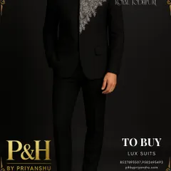 A full-length shot of the black Jodhpuri suit, paired with embroidered loafers. This view showcases the complete, cohesive look and its sleek, modern silhouette.