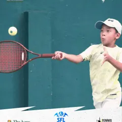 This young competitor executes a forehand with perfect timing, his eyes locked on the ball. It's this level of focus that we cultivate in our tournament environment.