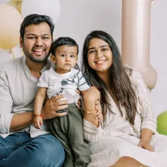 A happy family portrait from an at-home first birthday session. Celebrating this milestone together is what makes these photos so special.