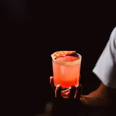 Held in hand against the darkness, the Pimento Paloma glows. It's a bold blend of tequila and grapefruit, with a jalapeño kick that keeps things interesting. This cocktail is as fiery as it is refreshing, crafted with pure passion.