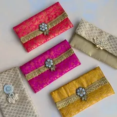 A collection of my brocade and silk shagun envelopes. Adorned with beautiful clasps and embellishments, these envelopes add a touch of luxury to the tradition of giving cash gifts.
