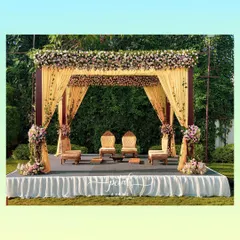 A contemporary wedding mandap perfect for an elegant outdoor reception. The structure is draped in beautiful yellow fabric and crowned with a thick border of assorted pastel roses, creating a look that is both modern and romantic.