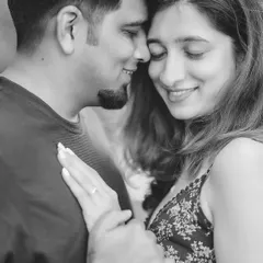 Another tender moment from their session, this black and white engagement photo showcases their gentle interaction and the detail of her ring.