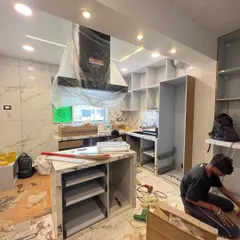 A behind-the-scenes look at our team during the kitchen installation process. Here, we are assembling the custom cabinetry and island, ensuring a perfect fit and finish for all components.