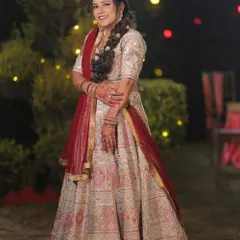 For me, a bridal lehenga should be a masterpiece. This stunning white and red lehenga features intricate embroidery and a classic silhouette, designed to make my bride feel like royalty on her special day.