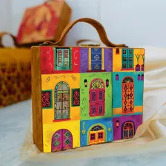 A vibrant and colorful suitcase-style bag featuring a collage of beautifully illustrated Indian doors and windows. This piece is a true conversation starter and adds a pop of color to any outfit.