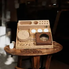 This all-in-one desk organizer, made entirely of cork, is a perfect sustainable gift. It includes coasters, candle holders, and compartments for stationery.