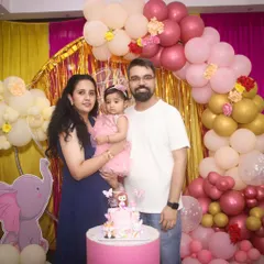 A beautiful family portrait in front of an elephant-themed birthday decoration. I always take posed family photos to remember the special day.