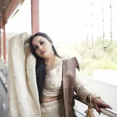 An artistic pose of the sister of the bride, showcasing her flowing dupatta and elegant hairstyle.