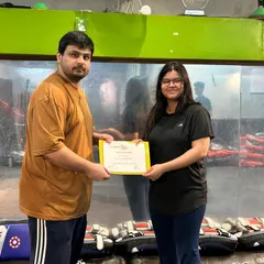 Presenting a certificate to a dedicated student. This represents hours of hard work, consistent training, and a new level of capability in self-defense.