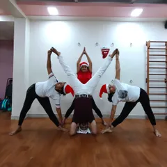 Another fun Christmas celebration pose. These moments of creativity and teamwork build a strong bond within our yoga family.