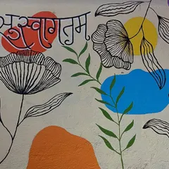 This 'Suswagatam' mural creates a warm and artistic welcome for any home or business entrance. The blend of colour blocks and line art gives it a modern feel.