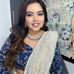 This angle shows how the dramatic eye makeup works with her soft, wavy hair and elegant jewelry. It's a complete look that is perfect for any evening celebration.