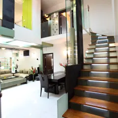 This project demonstrates our expertise in space transformation. We converted a dated 3BHK flat into a modern 4BHK duplex by removing non-structural walls and adding this striking staircase with illuminated wooden treads, which serves as a functional sculpture connecting the two levels.