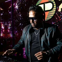 This is me in my element, focused on the mix at a corporate gala. I use professional Pioneer DJ gear to ensure the sound is perfect, while the custom LED visuals in the background create an immersive, high-energy atmosphere for your event.