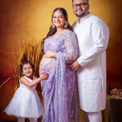 This portrait shows the whole family sharing in the joy of a new baby on the way. Dressed in coordinated traditional wear, their portrait is a beautiful blend of family love and cultural elegance.