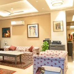 The living area in the Ganguly Residence is designed for comfort and conversation. We selected patterned sofas and traditional rugs to add warmth, while the curated artwork and layered tray ceiling bring a sense of refined elegance to the space.