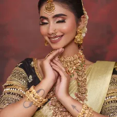 The joy of a bride feeling beautiful in her outfit. The tattoos on her arms add a personal and modern touch to the traditional ensemble.