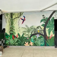 We call this our tropical paradise. We transformed the walls of a restaurant with a misty forest theme, covering even the doors to create a seamless, immersive jungle experience with colorful birds and lush greenery.