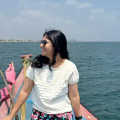A happy client enjoying the sea breeze and the beautiful view of the Chennai coastline during her boat ride.